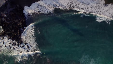 Top-Down-Aerial-View-of-Ocean-Waves-Breaking-on-Rocky-Coast-of-Tenerife,-Canary-Islands,-Spain