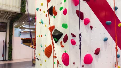 colorful climbing wall with various holds