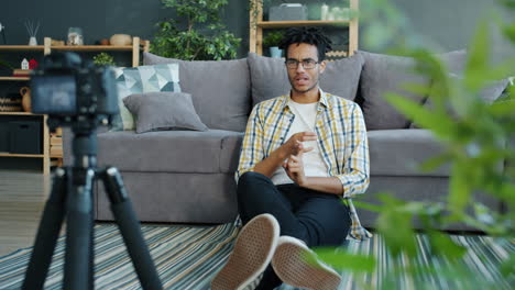 man vlogging in living room