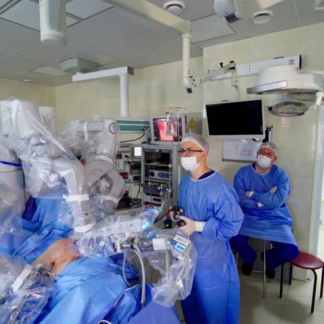 minimally invasive robotic surgery. robot arm performing surgical operation on patient