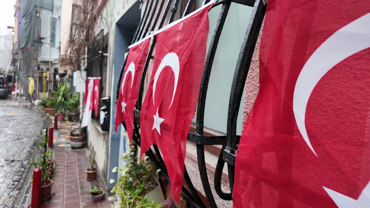 Turkish flags hanging from windows in a city street