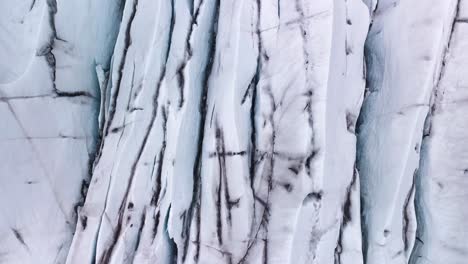 top-down drone aerial flight overlooking a stunning polar ice plateau on a glacier in iceland, europe