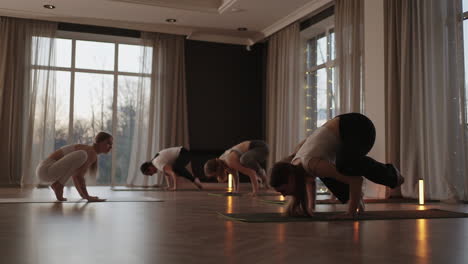 a group of women is engaged in stretching and balance with an instructor in a beautiful hall with large windows. healthy lifestyle group classes. joint training a common spirit