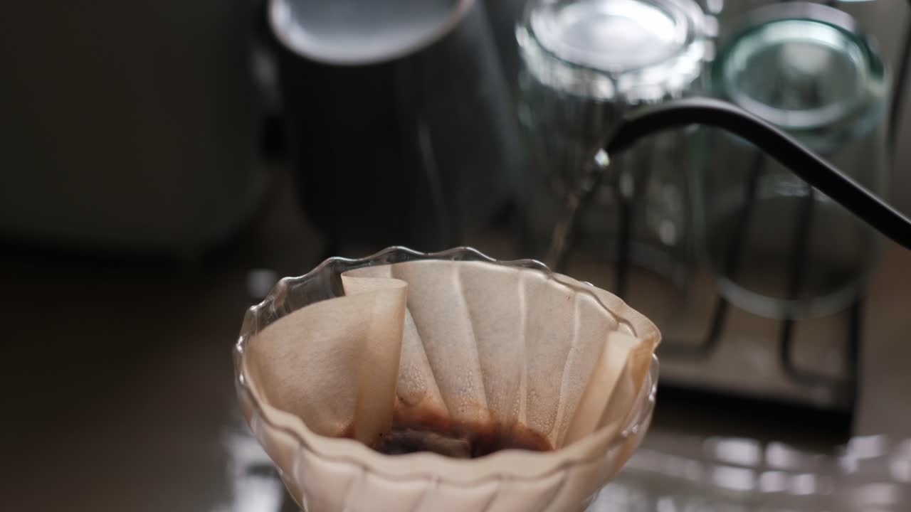 Close-Up Static Shot of Gooseneck Kettle Pouring Hot Water Into Paper Filter for Pour-Over Coffee Brewing