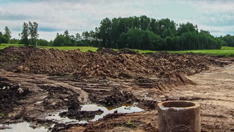 static shot of landscape transform into urban area with machinery in timelapse throughout a cloudy day