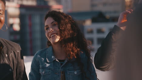 group of diverse friends hanging out together enjoying rooftop party at sunset beautiful mixed race woman drinking alcohol having fun socializing on weekend celebration