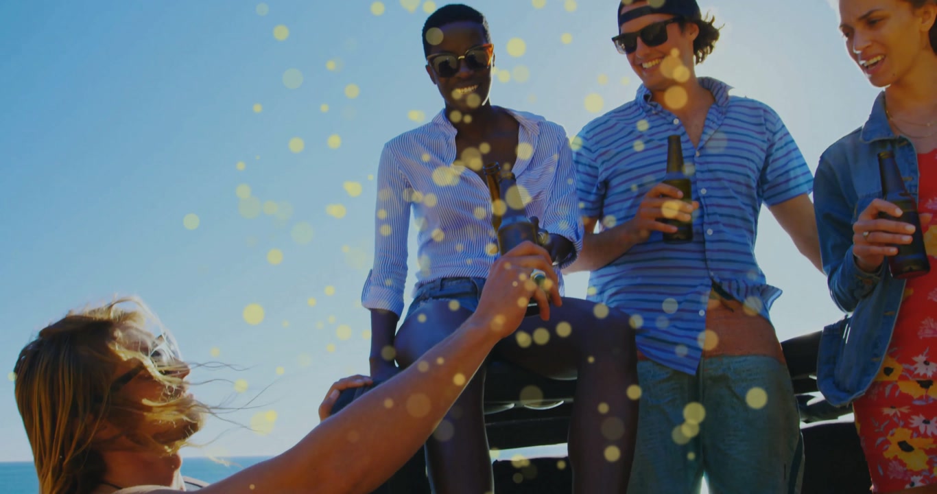 Opening tailgate friends grabbing beers from truck bed and toasting amid bokeh in lifestyle scene