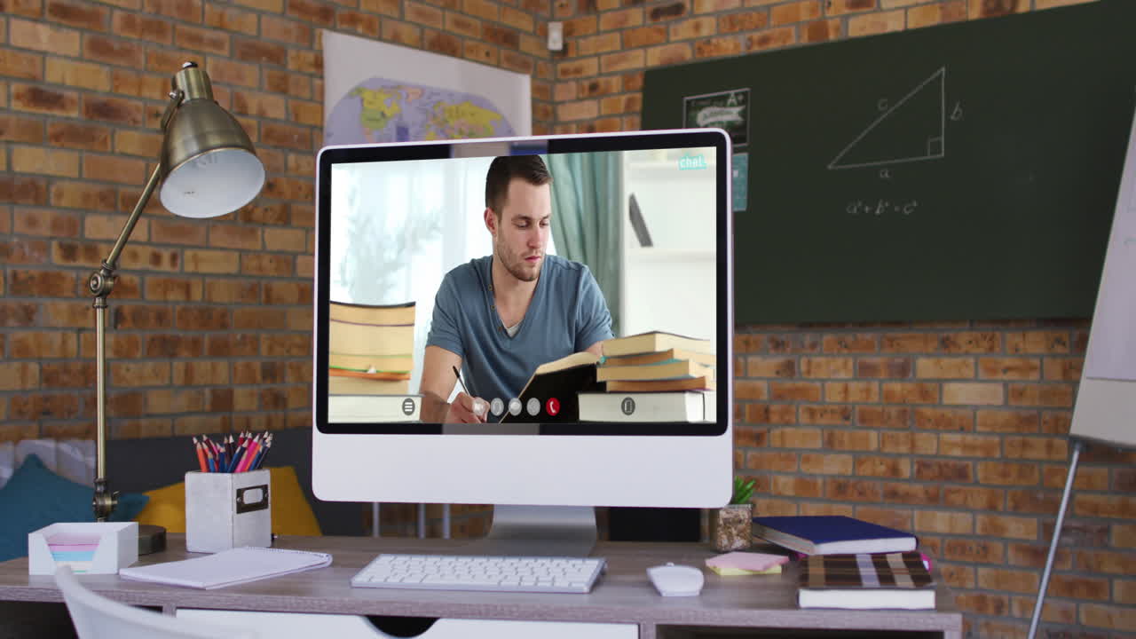 Caucasian male student learning displayed on computer screen during video call
