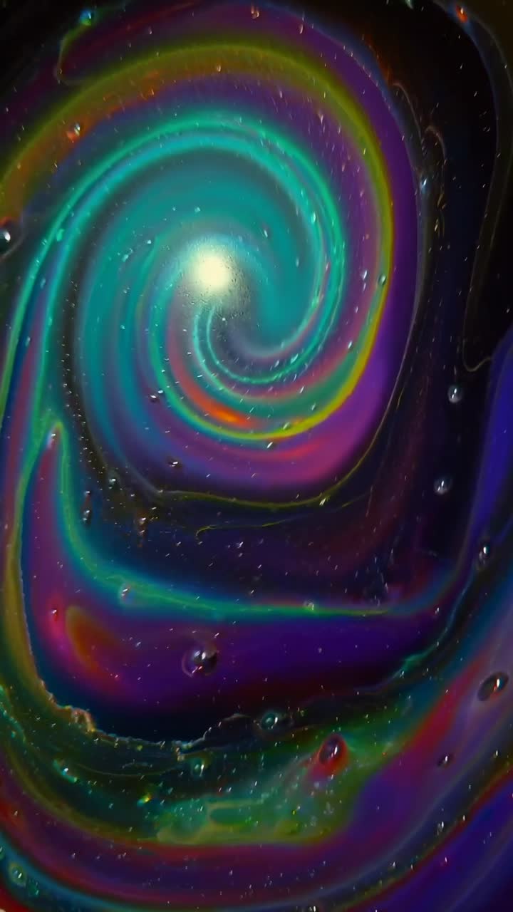 Vibrant, swirling colors in a top-down view, resembling a cosmic vortex