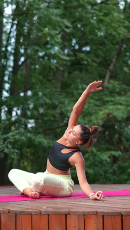 woman practicing yoga outdoors