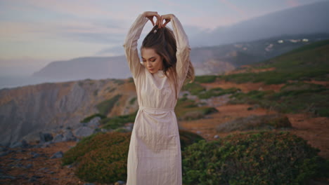 carefree lady dancing sunset sea cliffs zoom on. woman moving body at seascape