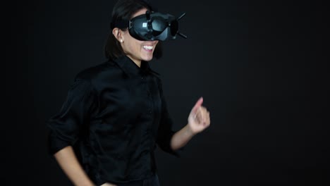 young female wearing vr goggles, waving to camera and starts running