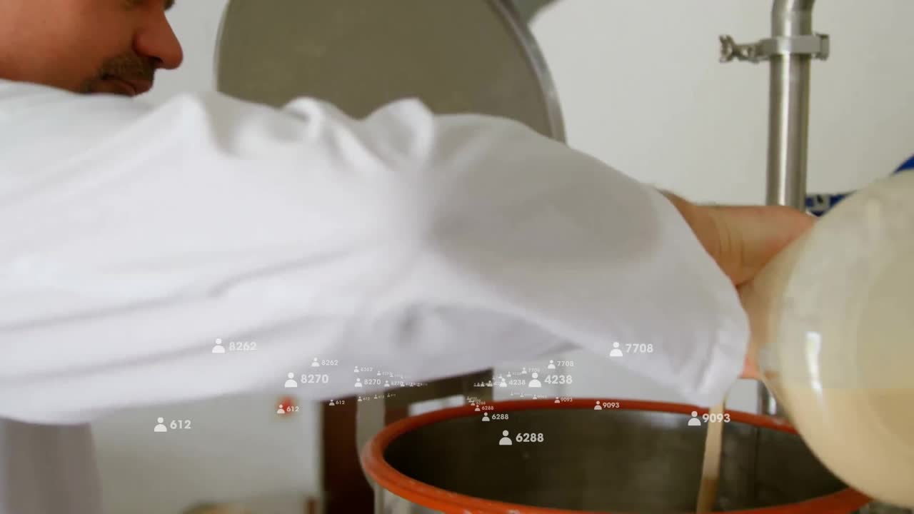 Lab tech positioning glass flask and pouring liquid through sieve into vessel in food processing
