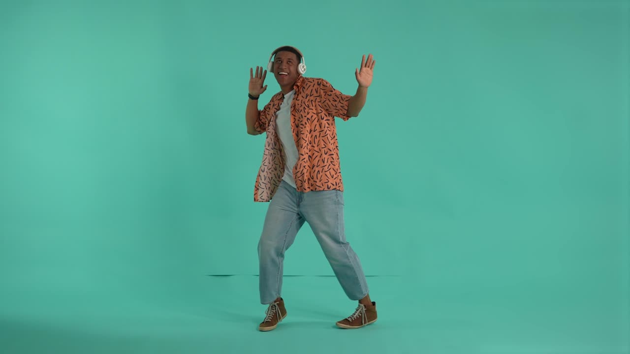 Young man in headphones having fun during dance