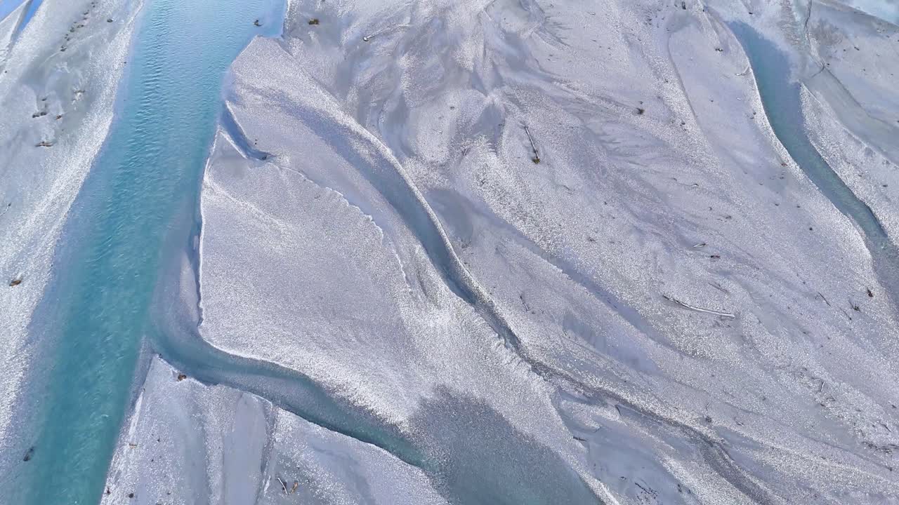 Aerial footage captures Glenorchy's winding river, showcasing its turquoise waters and surrounding terrain under soft daylight