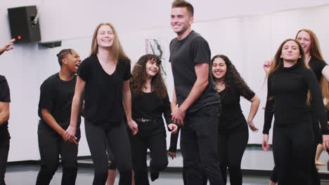 Estudiantes-Masculinos-Y-Femeninos-De-La-Escuela-De-Artes-Escénicas-Saltando-En-El-Aire-Durante-El-Ensayo-De-Danza