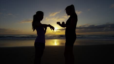 ethnic american women on beach doing sport fitness