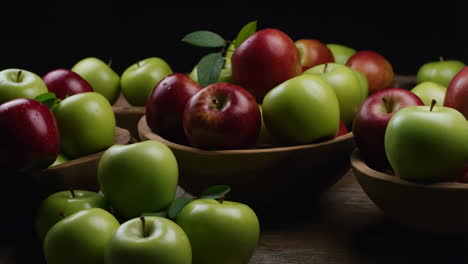 fresh red and green apples in wooden bowls on a dark background