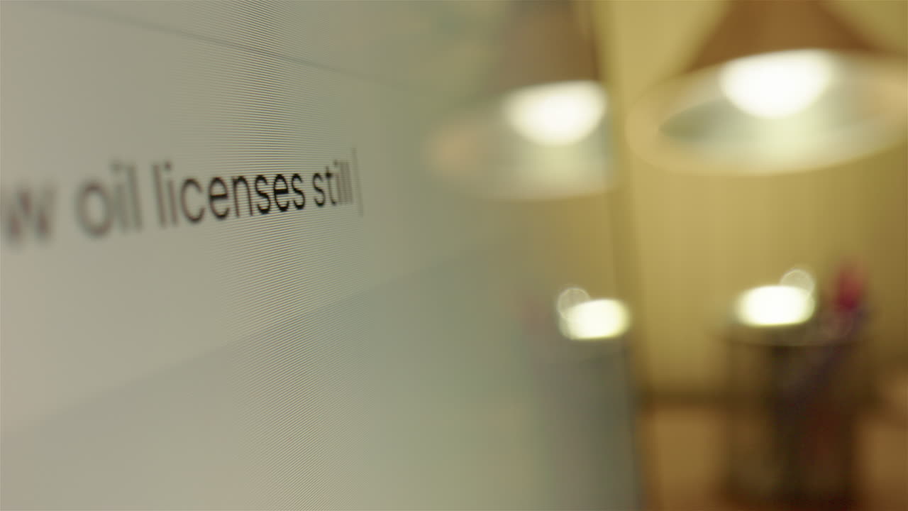 Searching internet why oil licenses are still being handed out, closeup slider