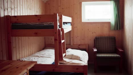 interior of a wooden cabin bedroom with double bunk beds