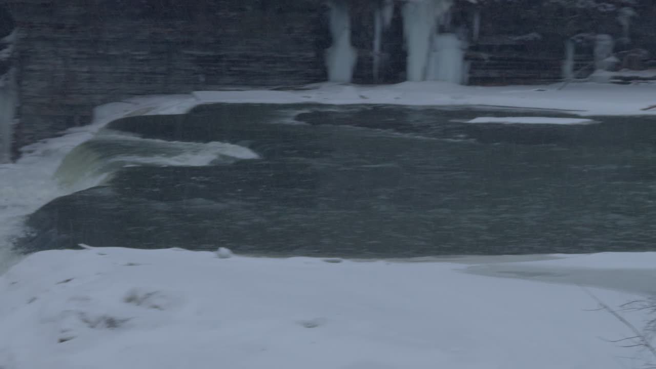 Frozen waterfall on river stream, winter season