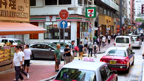 pedestrians and vehicles navigate a bustling street