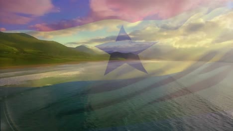 digital composition of ghana flag waving against aerial view of waves in the sea