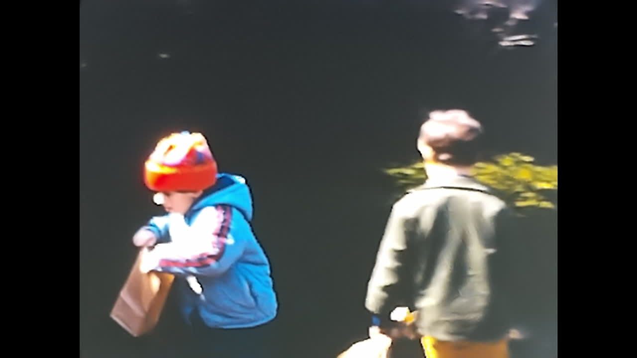 Group of People Standing in Front of Blue House. CIRCA USA - 1970s: A group of people from the 1970s in the USA standing together in front of a blue house.