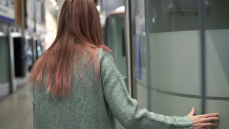 caucasian woman in store chooses a shower stall for the bathroom