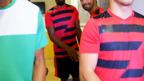 Two-soccer-teams-greeting-while-leaving-the-locker-room-4k