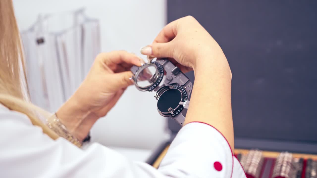 Ophthalmology eyesight diagnostic. Optometrist holding messbrille in ophthalmology clinic