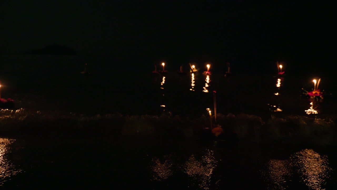 Floating Candles on Water at Night