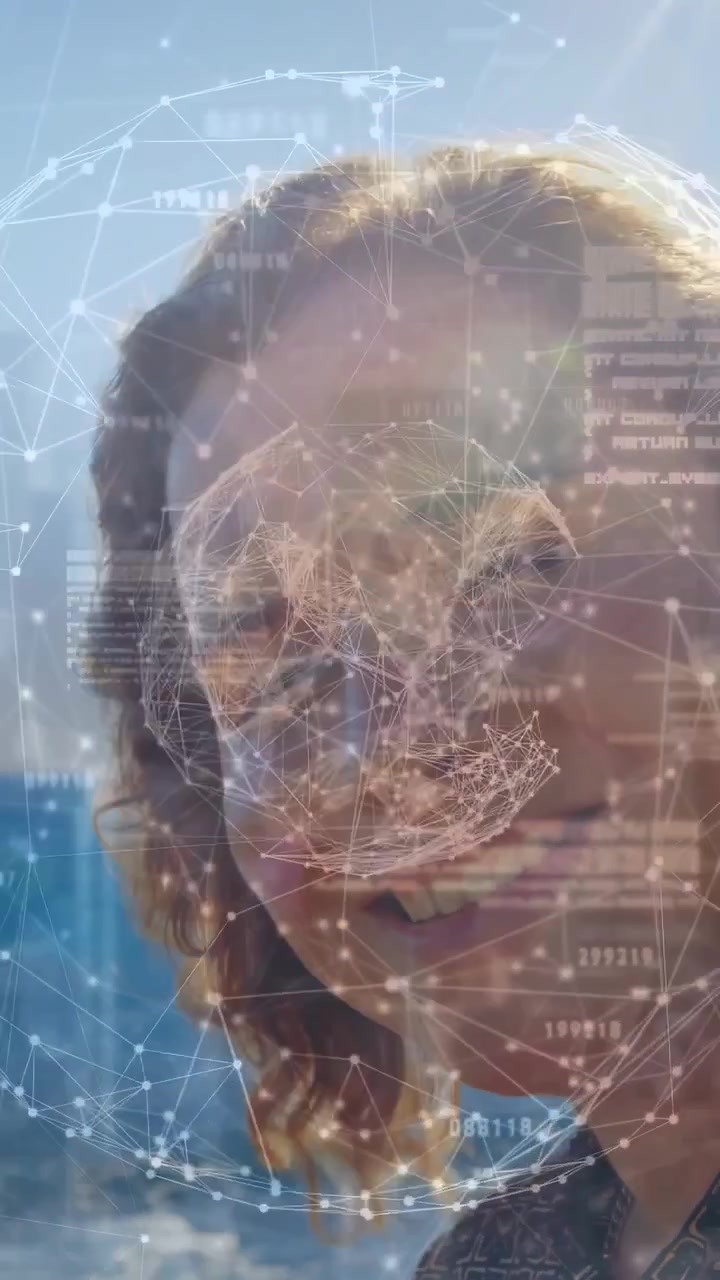 Vertical video: Woman turning head to camera causing AR sphere mapping face by sunlit ocean