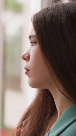 woman eyes linger on steady rainfall outside. businesswoman feels grip of hopelessness tightening around suffocating any semblance of optimism