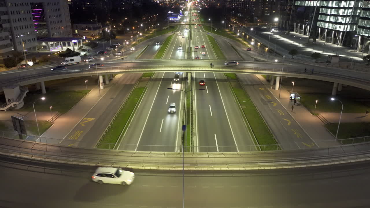 Night traffic on a multi-lane highway in an urban setting