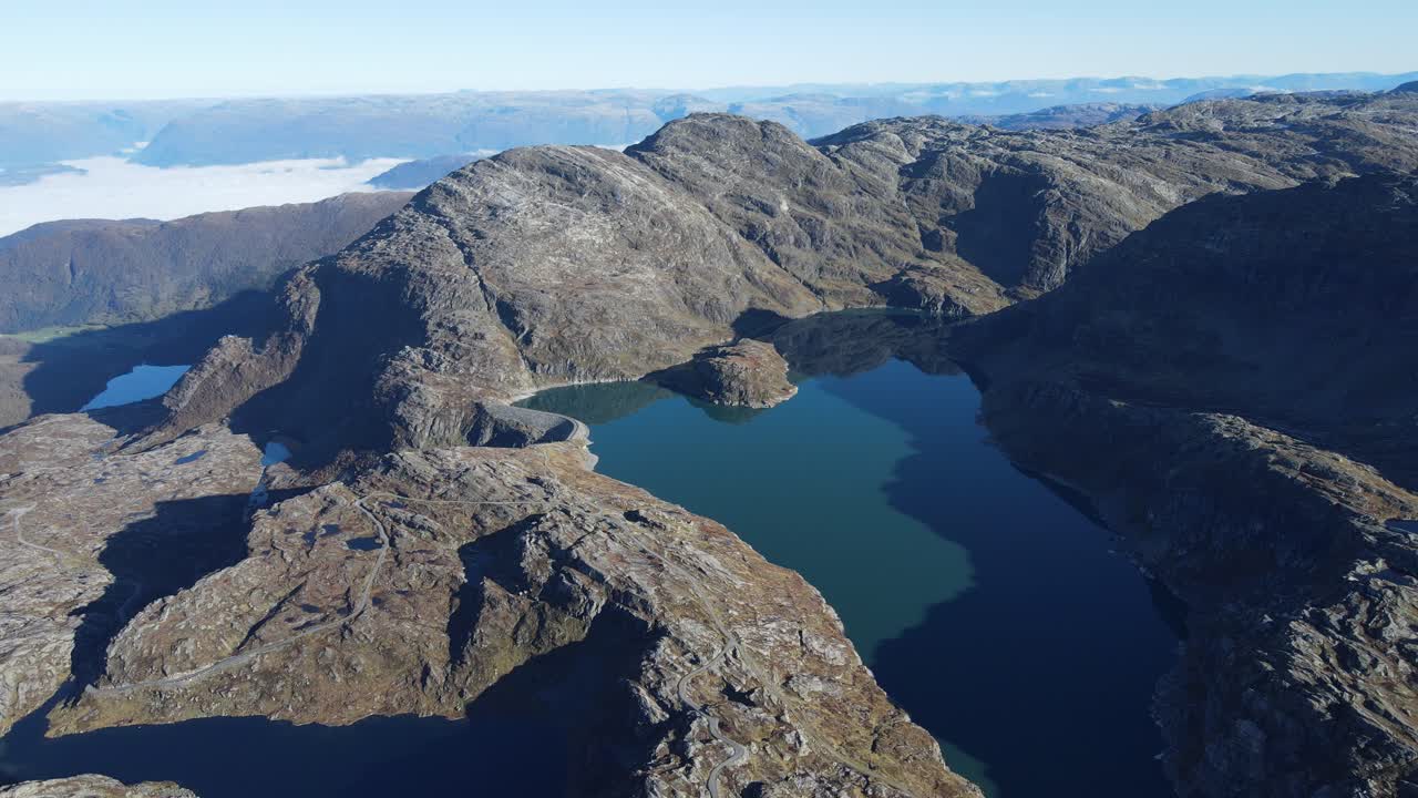 Zooming out drone footage of glacier lake in Folgefonna National park in Norway. Hardanger fjord visible in a far