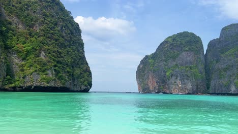 Maya-Bay-in-Phi-Phi-Islands-National-Park,-wave,-sand-beach,-and-beautiful-crystal-clear-water-at-a-popular-tourist-destination-in-Krabi,-Southern-of-Thailand