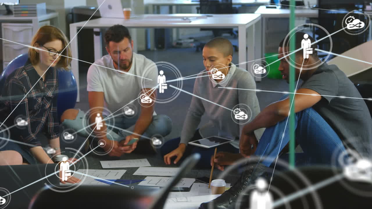 Animation of network of digital icons over team of diverse colleagues discussing together at office