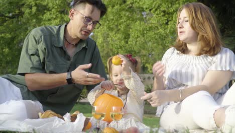 a young happy family at the picnic in the city park