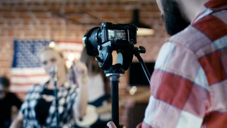 man taking video of band show