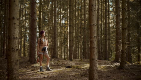 young woman looking around forest