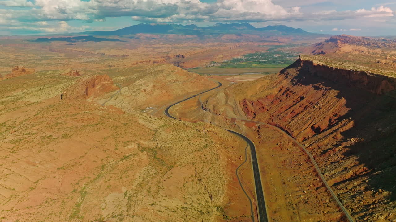 Amazing scenery of splendid canyons lit with sun. Clouds in blue sky at backdrop. Aerial perspective.