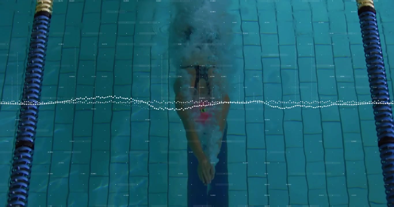 Woman swimmer diving from pool edge, initiating butterfly stroke in pink cap for swimming training