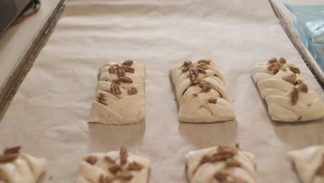 unbaked pecan pastries on a baking sheet