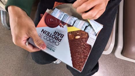 person unboxes multiple chocolate bars from packaging