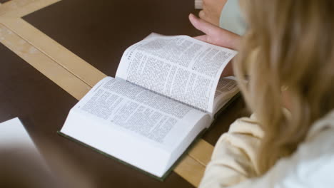 Blond-kid-reading-the-Bible-in-class