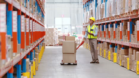 warehouse worker using digital tablet while checking packages