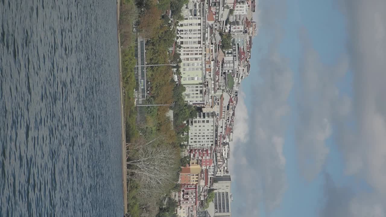 Cityscape reflected in a lake on a cloudy day