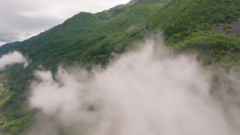 Aerial-over-mysterious-swirling-mountain-fog,-Hardanger-fjord-Norway