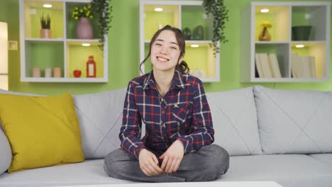 Cute-Asian-woman-waving-towards-camera.